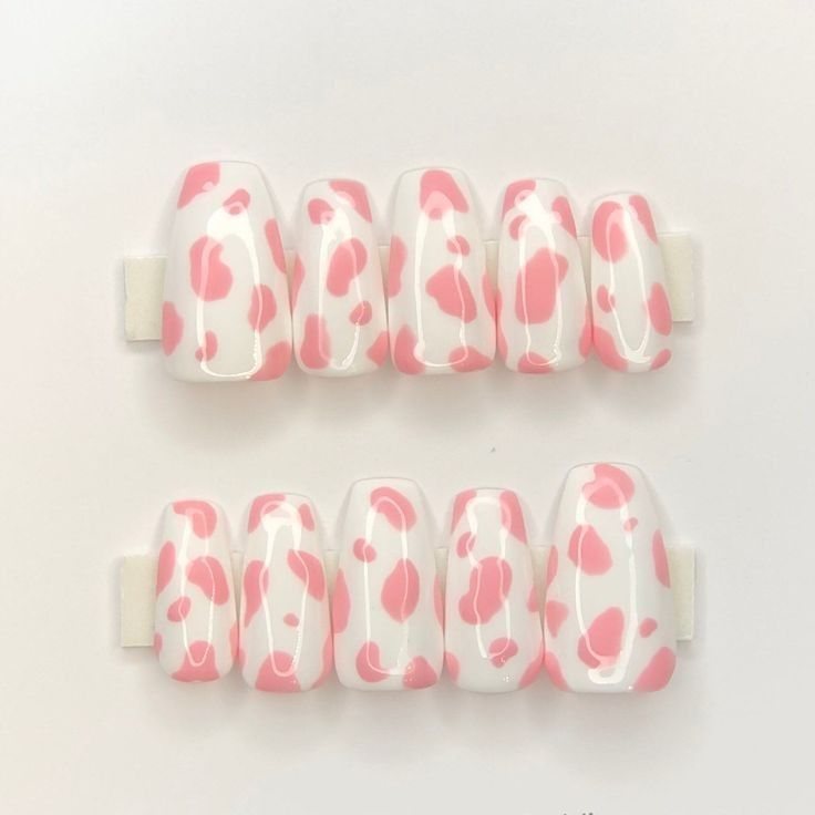 White press-ons with pink hand painted cow print